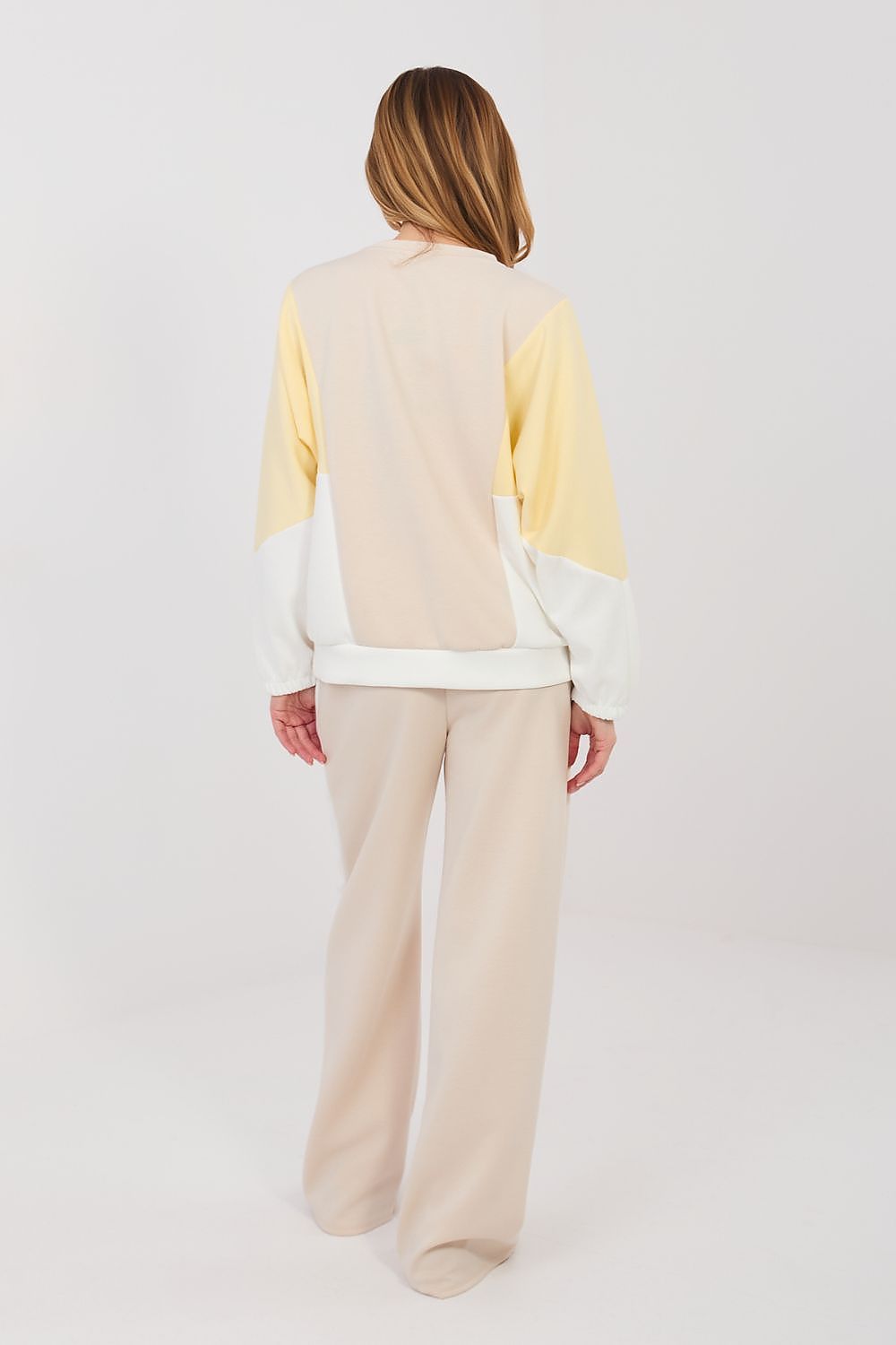Beige two-piece lounge set with long-sleeve sweatshirt and wide-leg pants, back view