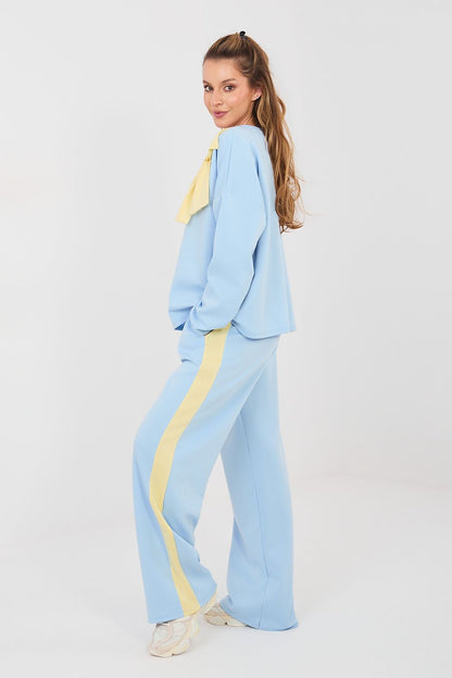 Light blue two-piece set with long-sleeve blouse and wide-leg pants, yellow side stripe