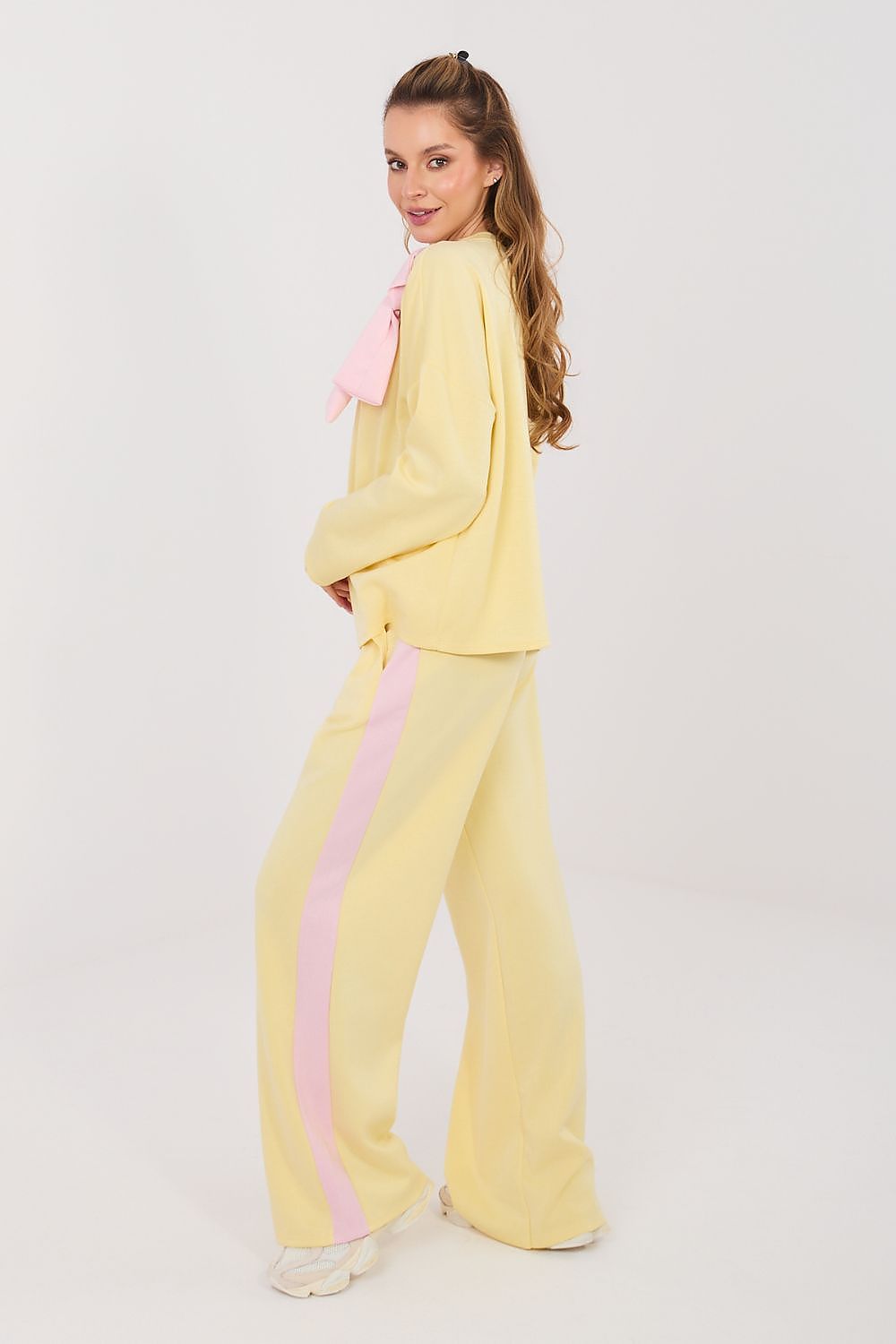Yellow two-piece set with long-sleeve blouse and wide-leg pants, pink bow and accents