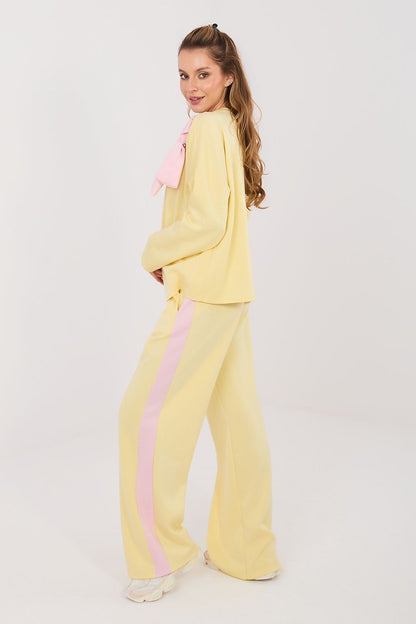 Yellow two-piece set with long-sleeve blouse and wide-leg pants, pink bow and accents