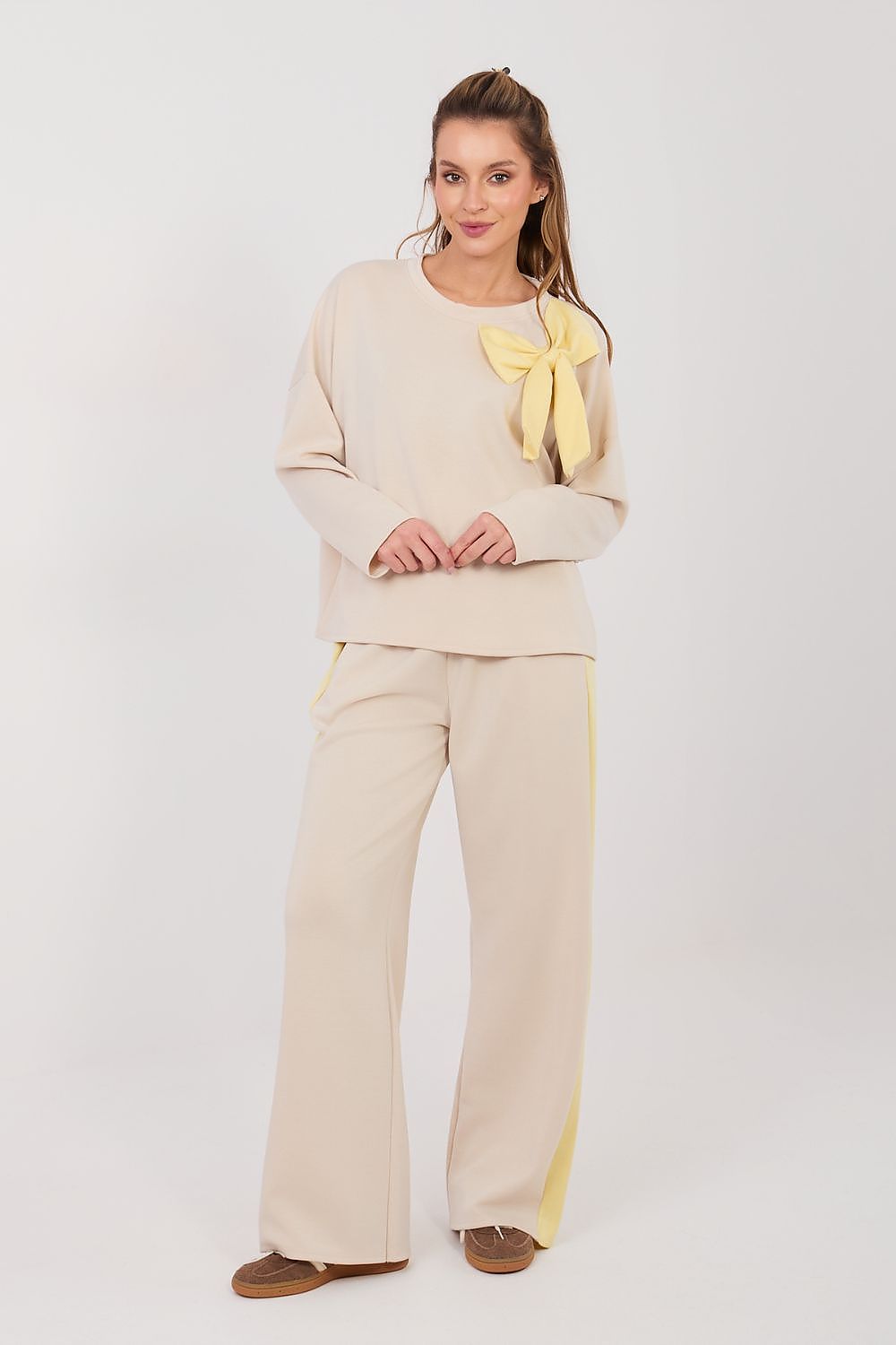 Cream pants and top set with long sleeves and matching wide-leg trousers, bow