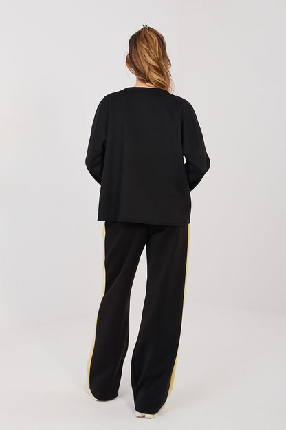 Black two-piece set with long sleeves and yellow side stripe, wide-leg pants
