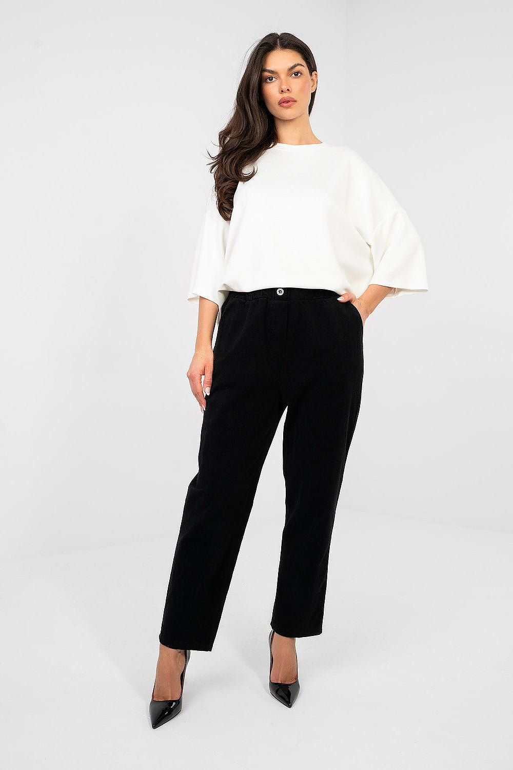 Black corduroy trousers with high-rise button waistband, belt loops and tapered legs