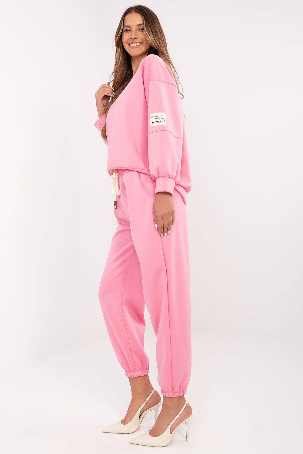 Pink sweatshirt with dropped shoulders and matching jogger pants, cuffed hems
