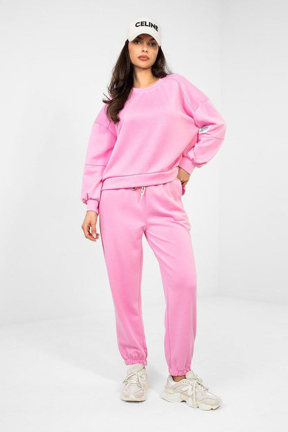 Pink sweatshirt and jogger set with long sleeves and drawstring waist