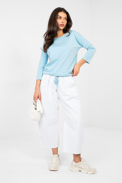 Light blue blouse with round neckline and 3/4 sleeves, loose drape