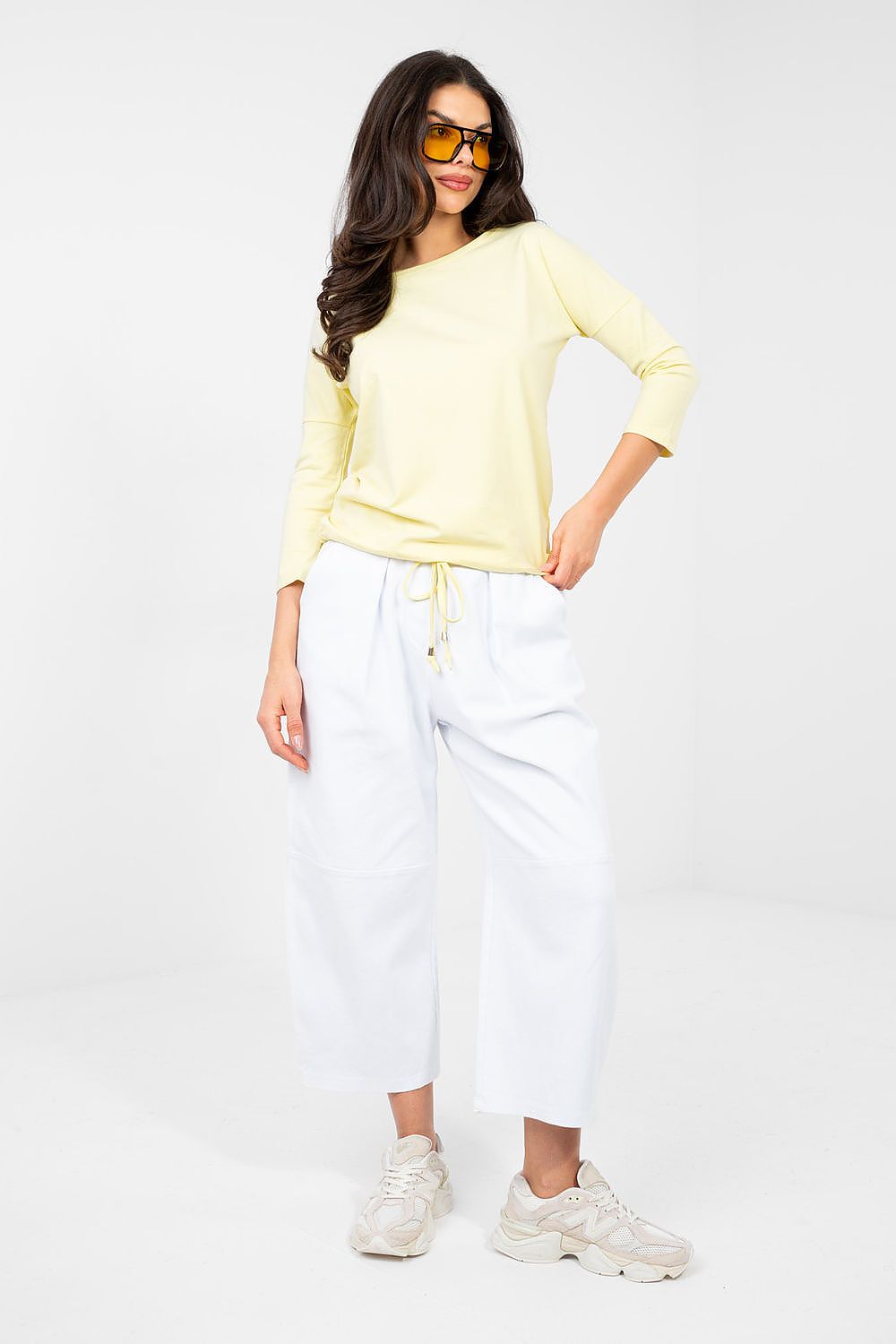 Light yellow blouse with round neckline and 3/4 sleeves, side view