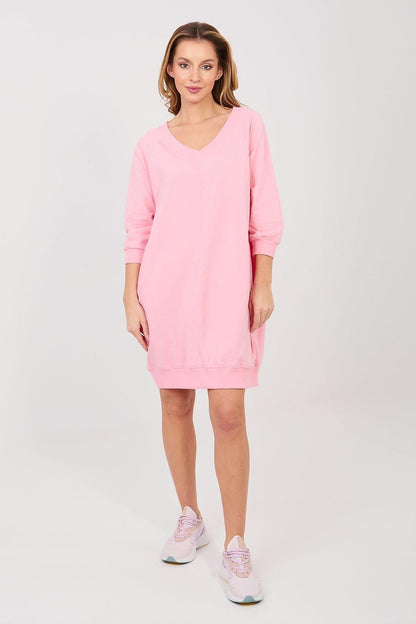 Pink daydress with V-neck and three-quarter sleeves, loose above-knee hem.