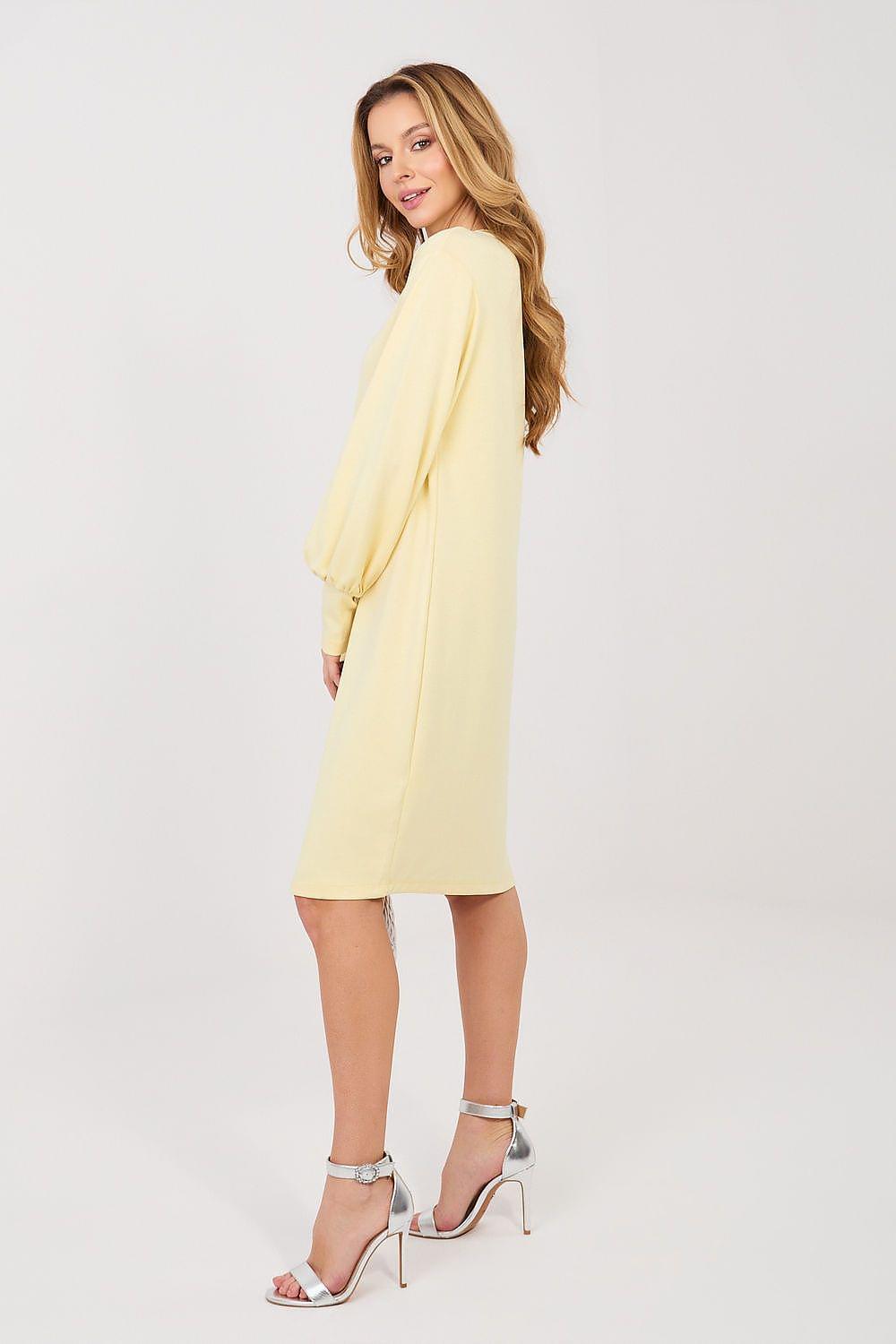 Yellow daydress with long puff sleeves and round neckline, knee-length straight silhouette