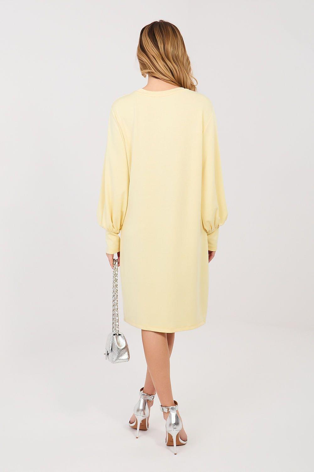Yellow daydress back view with long sleeves and elastic cuffs, knee-length silhouette