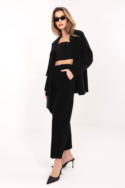Black corduroy high-waist trousers with side pockets and tapered ankle length