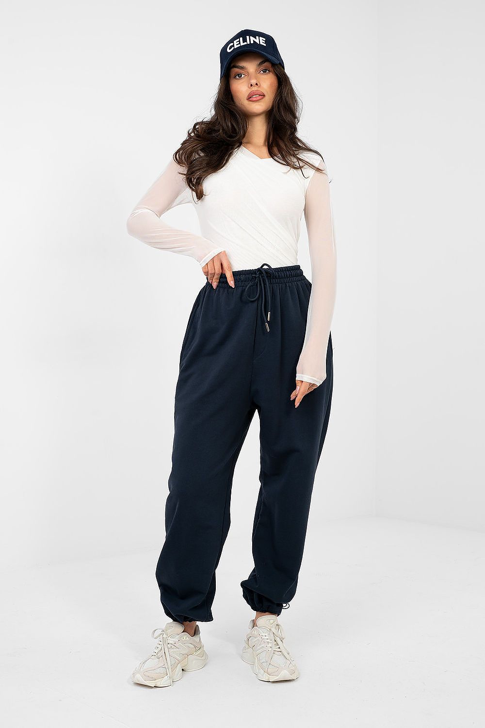 Navy blue tracksuit trousers with elastic waist, drawstring, and cuffed hems