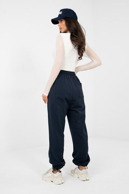 Navy blue track trousers with elastic waistband, drawstring tie, cuffed legs