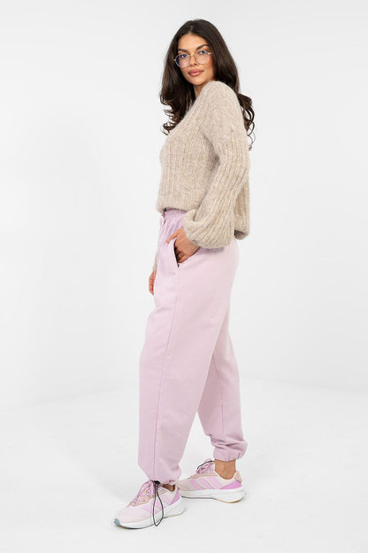Light pink jogger trousers with drawstring elastic waist and cuffed tapered legs