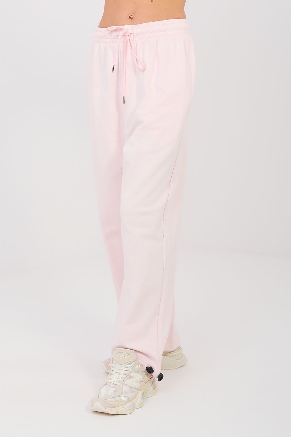 Light pink tracksuit jogger trousers with drawstring elastic waist and front seams