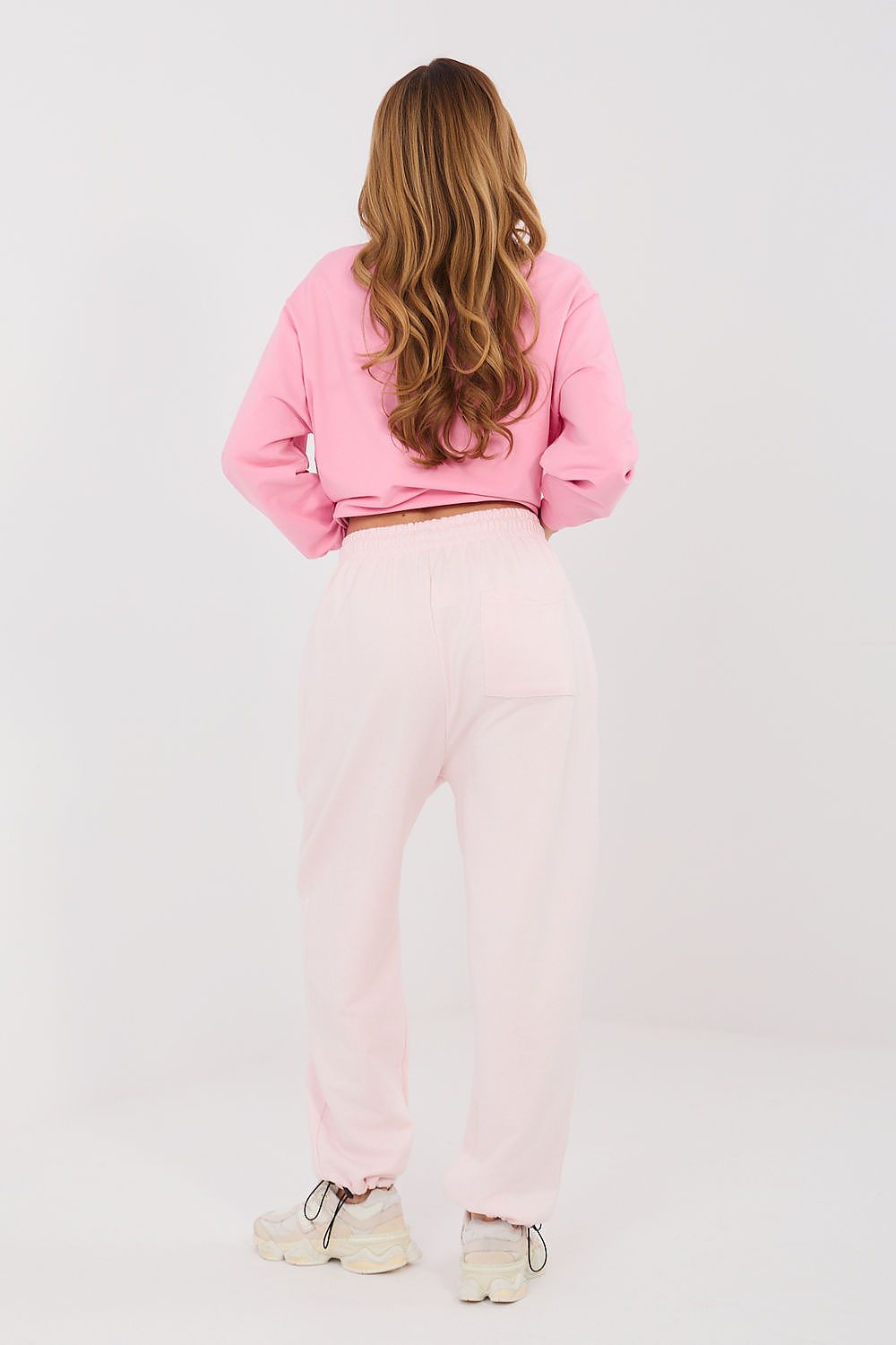 Light pink tracksuit jogger trousers with elastic waist and cuffed legs