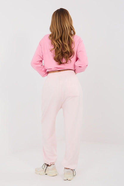 Light pink tracksuit jogger trousers with elastic waist and cuffed legs