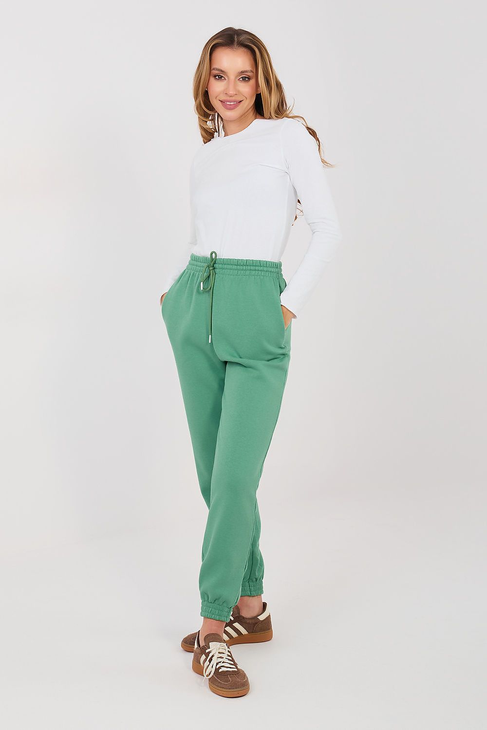 Green tracksuit jogger trousers with drawstring waist and ankle cuffs.