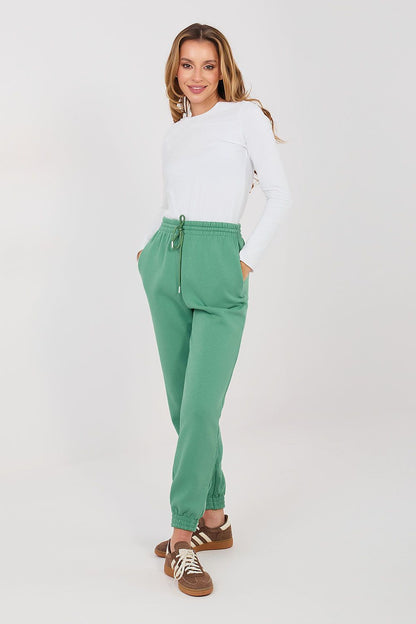 Green tracksuit jogger trousers with drawstring waist and ankle cuffs.