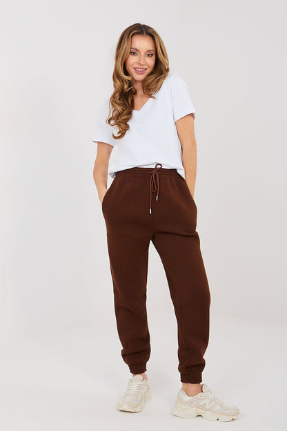 Brown tracksuit jogger trousers with drawstring waist and elastic ankle cuffs.