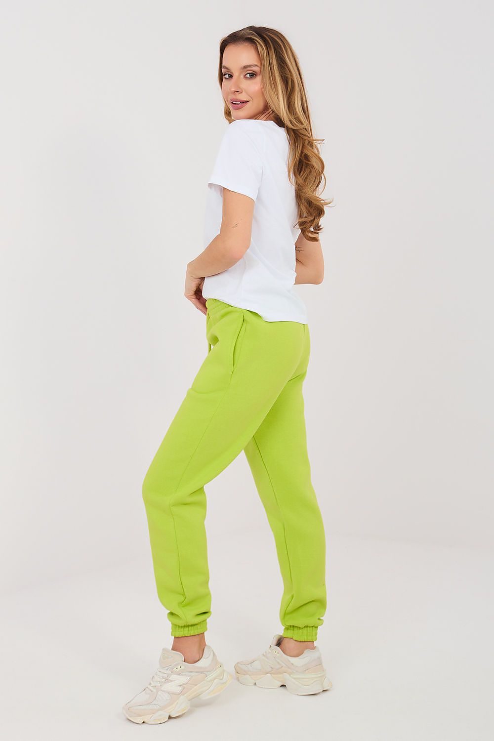 Lime green track jogger trousers with tapered legs, drawstring waist, elastic cuffs
