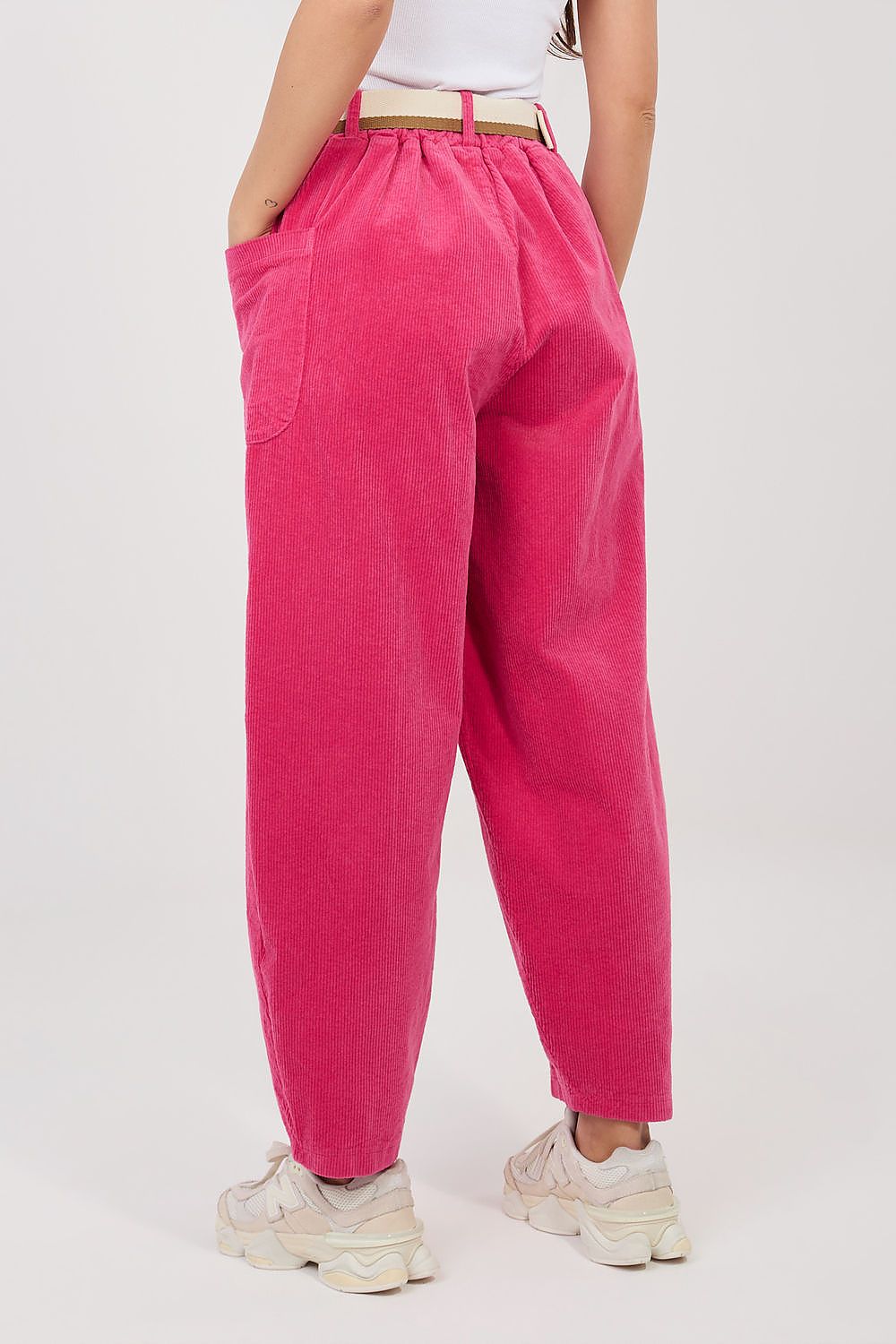 Bright pink corduroy trousers with elastic waist, belt loops, and ankle cuffs.