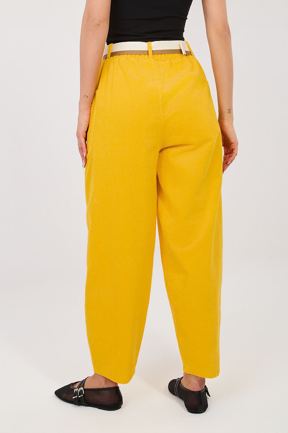 Mustard yellow corduroy trousers with belt loops and relaxed straight-leg fit.