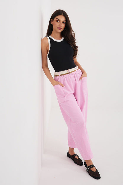 Corduroy trousers in pink corduroy, side view with belted waist and tapered legs