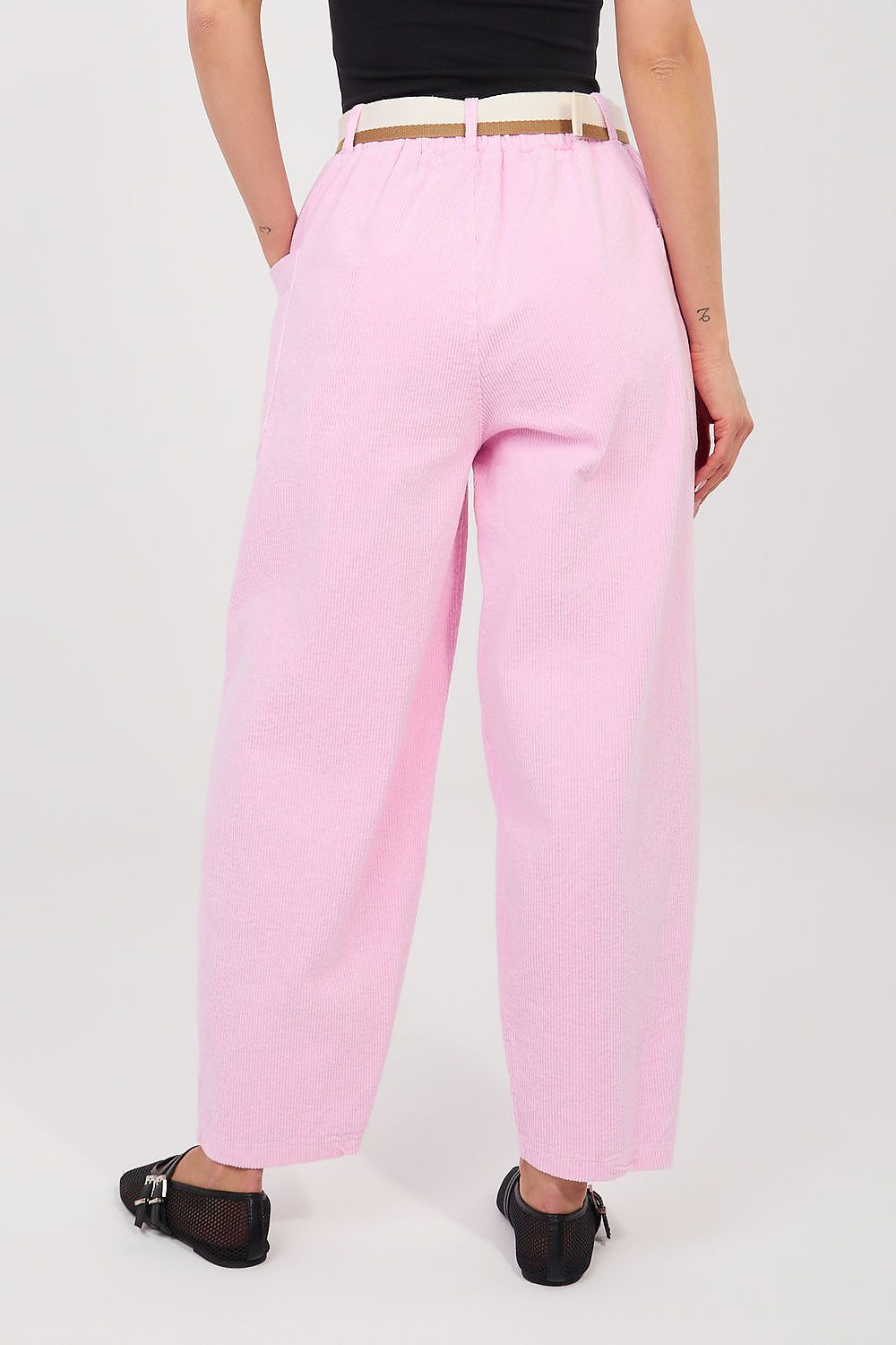 Corduroy trousers in pink corduroy, back view with belted waistband and wide hems