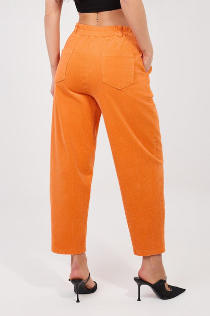 Orange corduroy high-waist trousers with back patch pockets and tapered leg