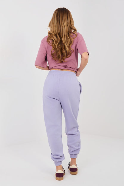 Lavender track jogger trousers with elastic cuffs and drawstring waist (back view)
