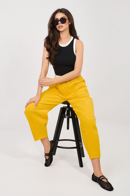 Black sleeveless tank top with white crew neckline and armhole trim.