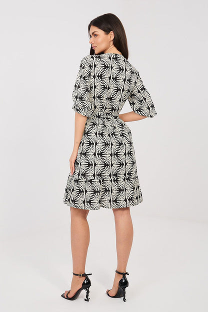Black-and-white patterned daydress with 3/4 sleeves and flared skirt, waist belt at back