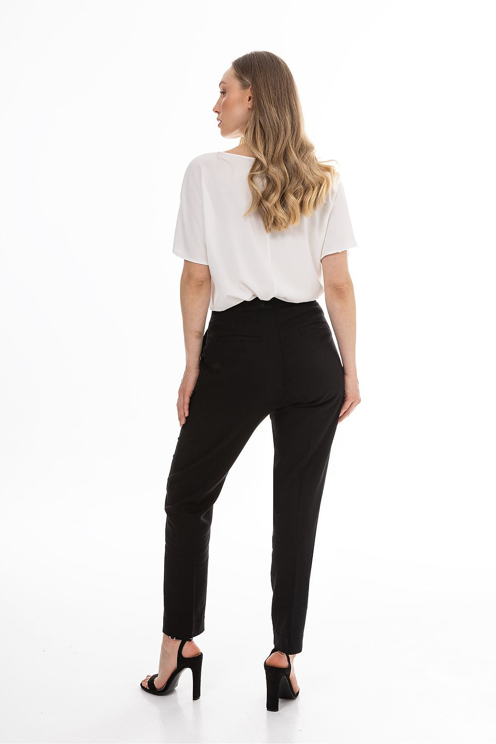 Women’s tailored trousers in black with tapered legs and visible back yoke seam