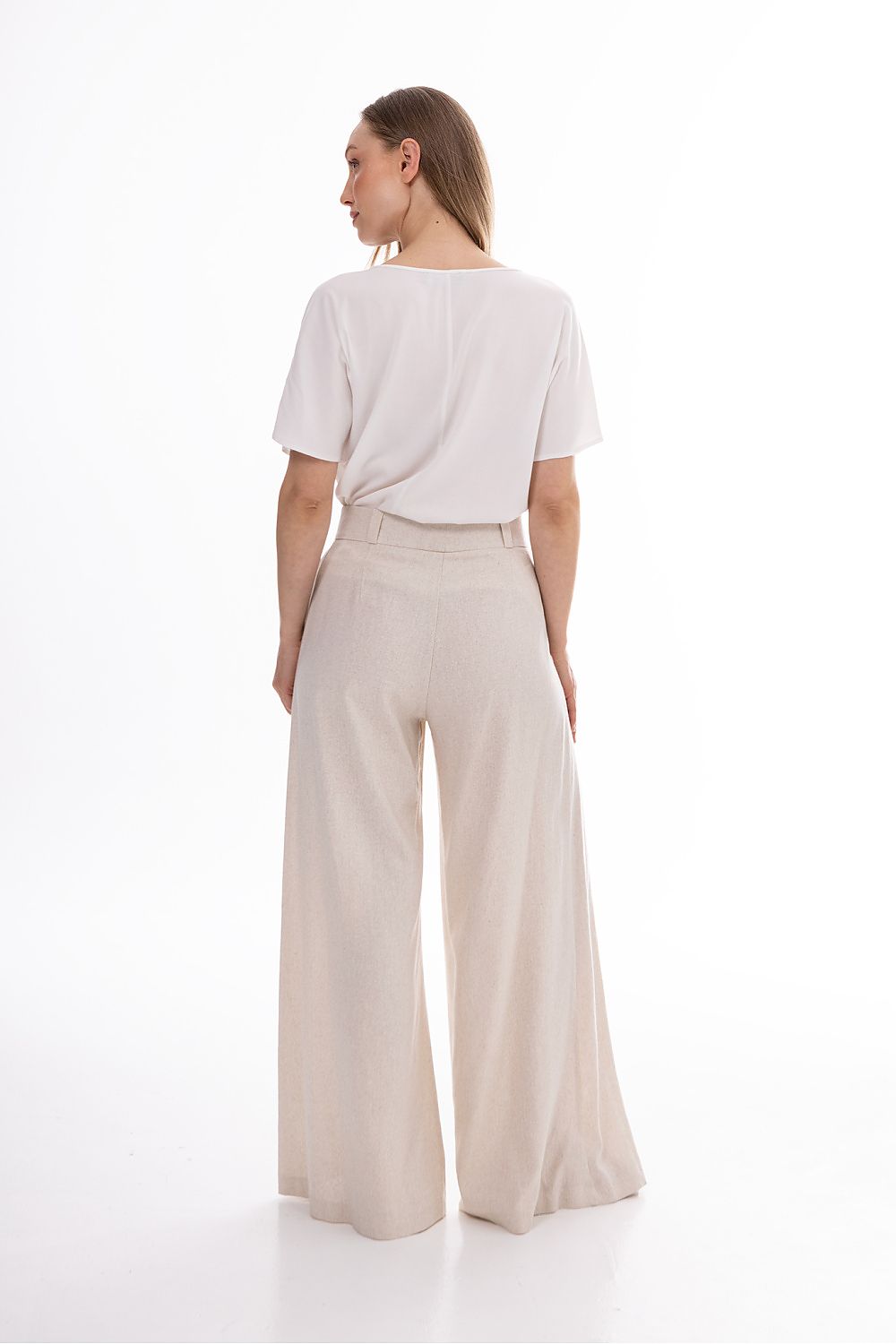 Awama women’s wide-leg trousers, light beige, back view with high waist and pleats