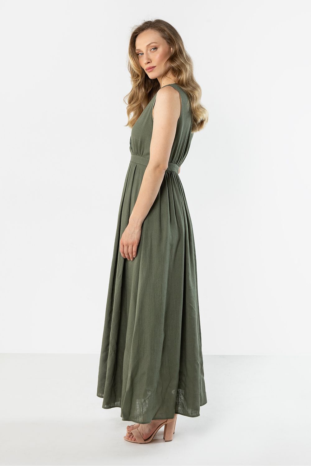 Green sleeveless V-neck daydress with belted waist and full maxi skirt, side view