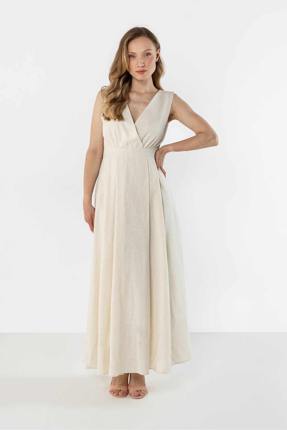 Beige sleeveless maxi daydress with V-neck and gathered waist seam, flowing A-line skirt