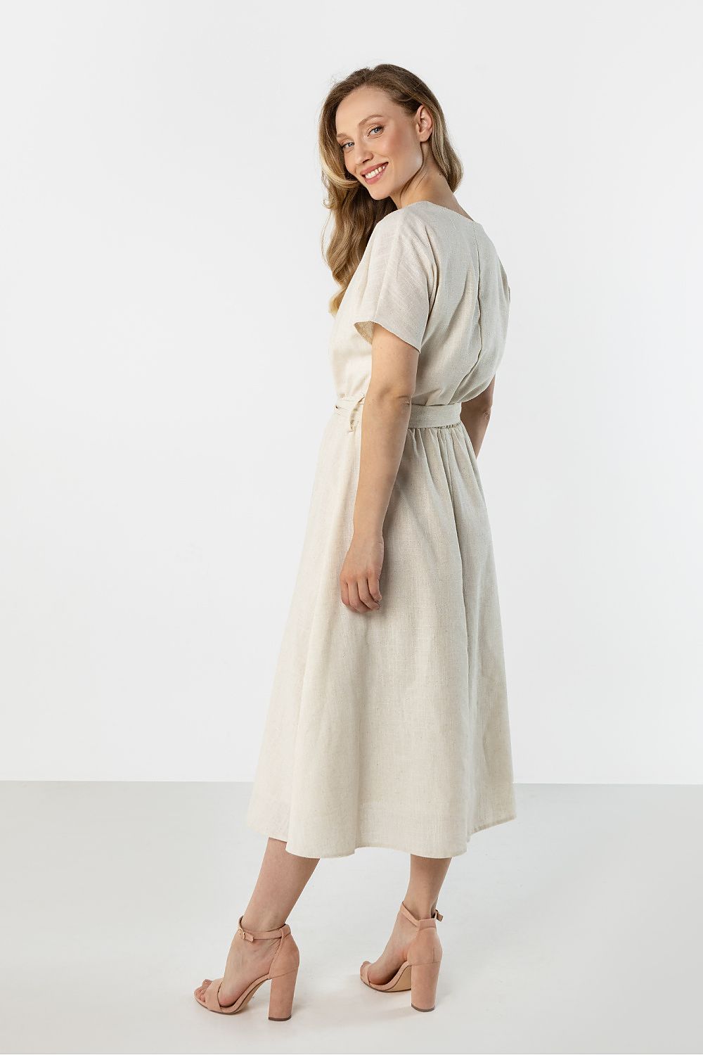 Light beige day dress with short sleeves and gathered waist, side view