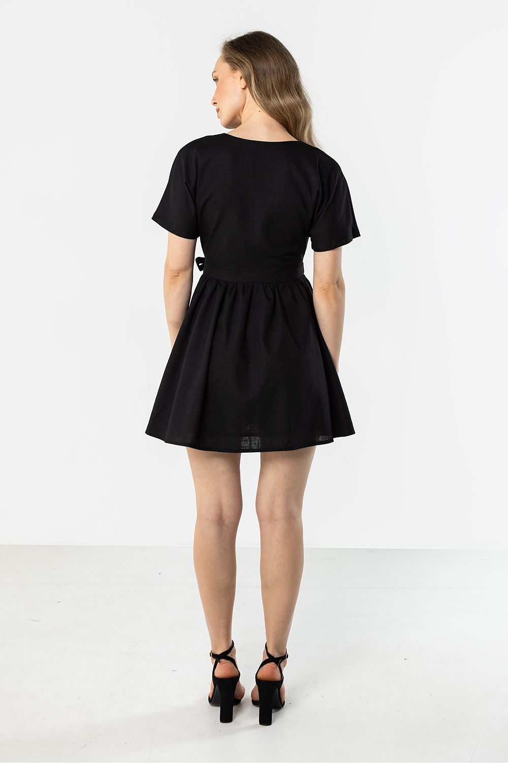 Black short-sleeve daydress, back view, gathered waist and flared skirt