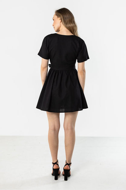 Black short-sleeve daydress, back view, gathered waist and flared skirt