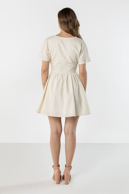 Cream short-sleeve daydress, back view, gathered waist and flared skirt