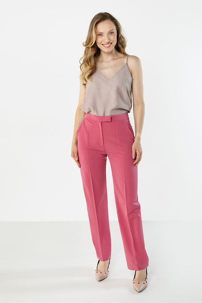 Pink trousers with belt loops, front pleats, and tapered ankle-length legs