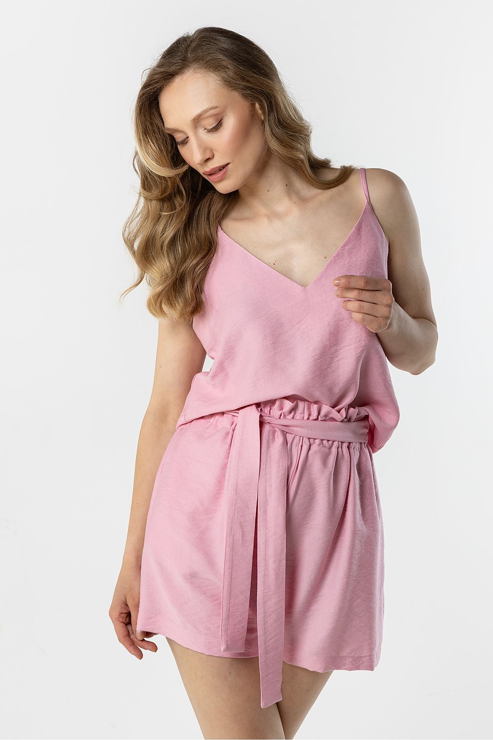 Pink sleeveless V-neck belted romper with elastic waist and short legs