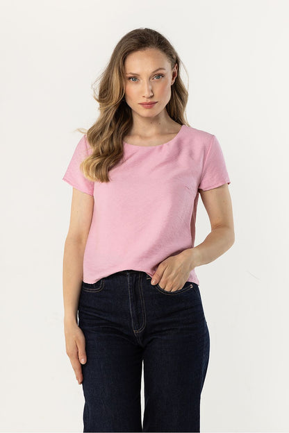 Pink short-sleeve crewneck blouse with smooth fabric and relaxed fit