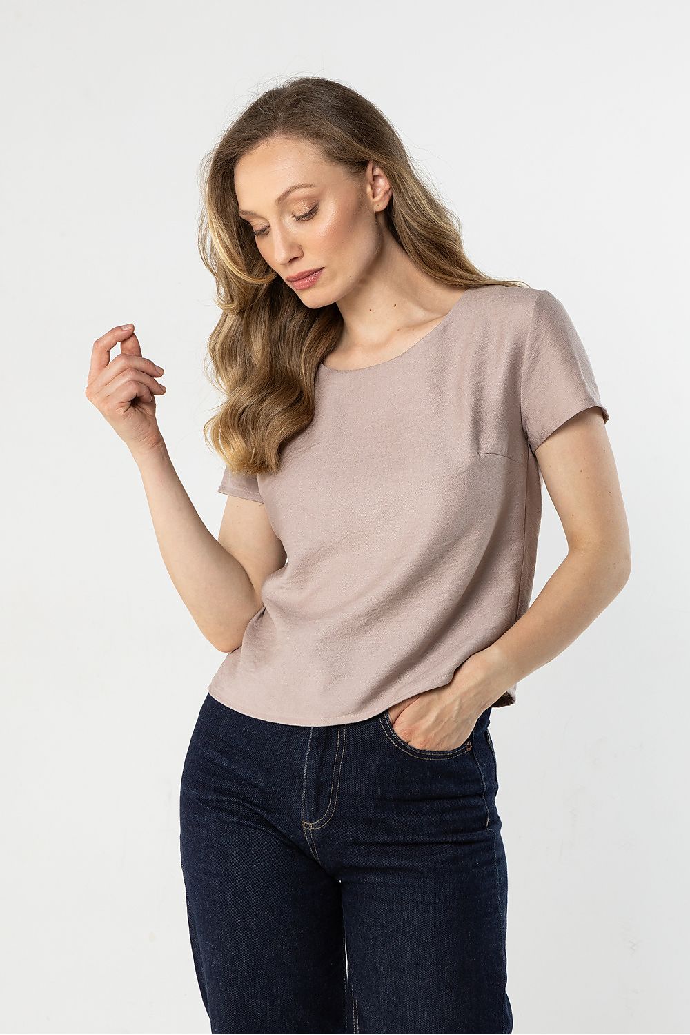 Beige short-sleeve crewneck blouse, angled front view with draped fit