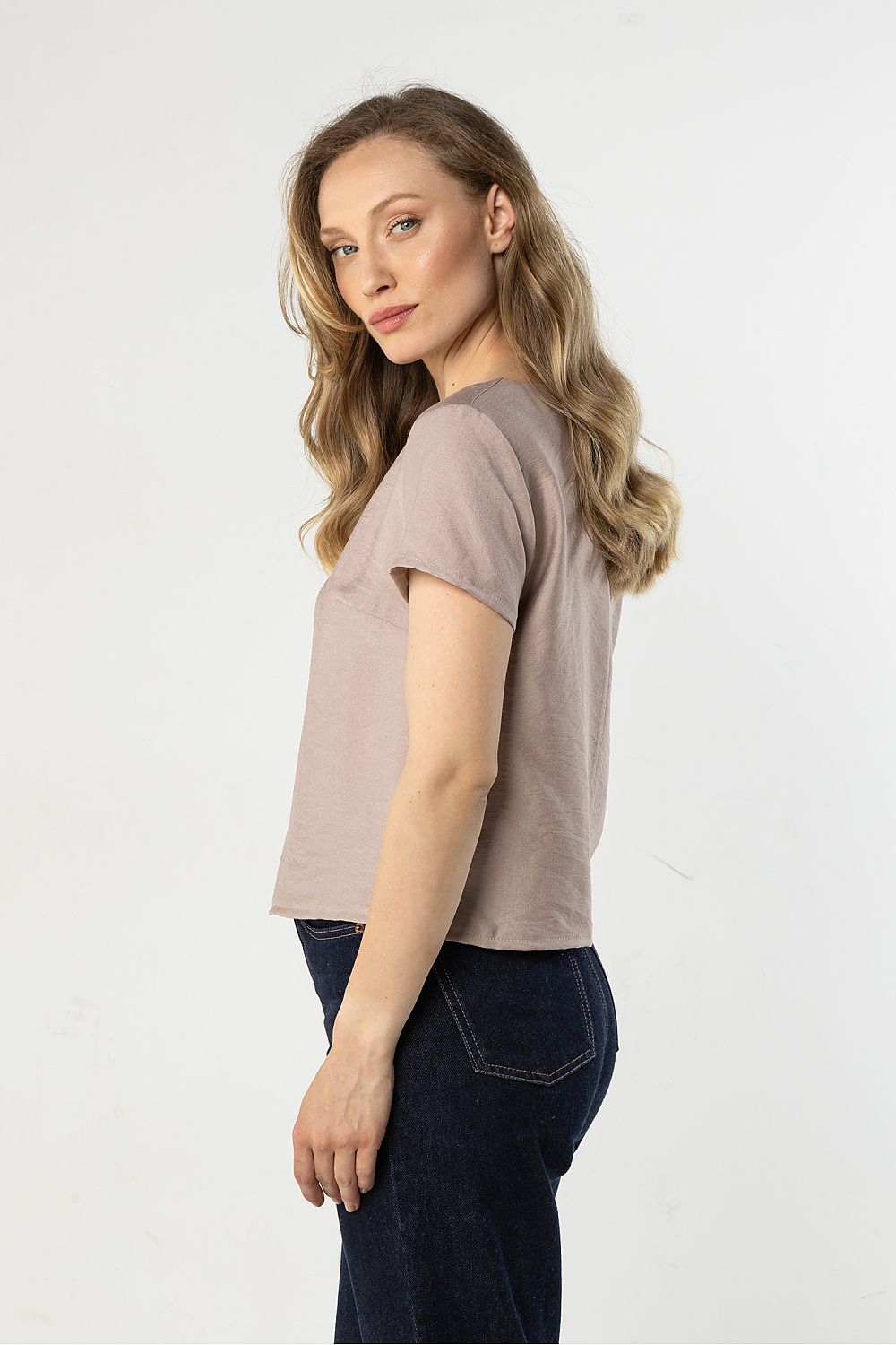 Beige short-sleeve crewneck blouse, side view with straight hem