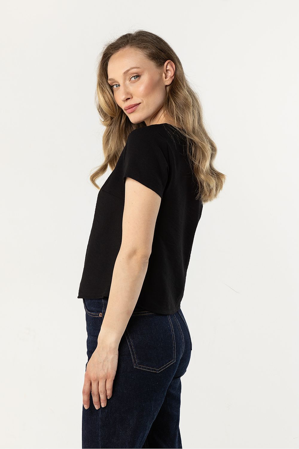 Black short-sleeve blouse with round neck, side view, loose fit