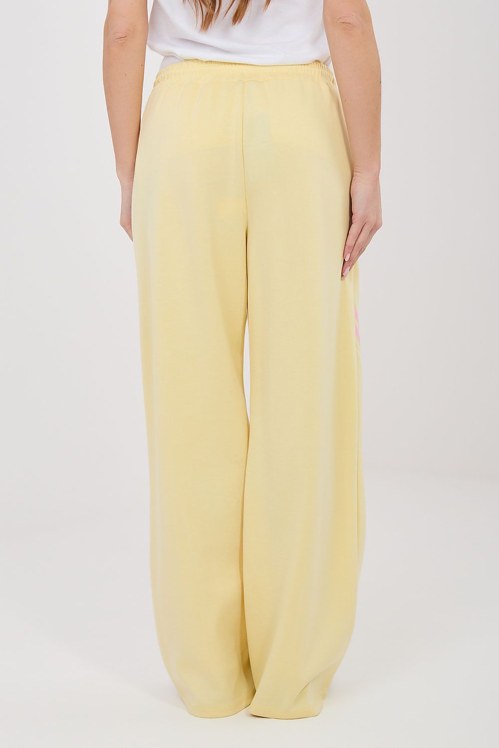 Tracksuit trousers, pale yellow wide legs with elastic drawstring waist, straight front