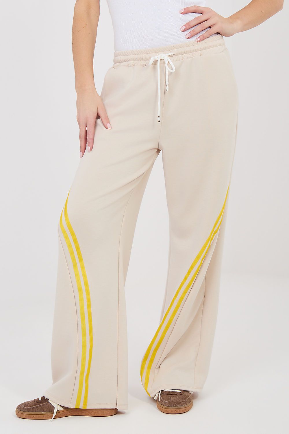 Tracksuit trousers, light beige wide-leg pants with yellow side stripes and drawstring waist