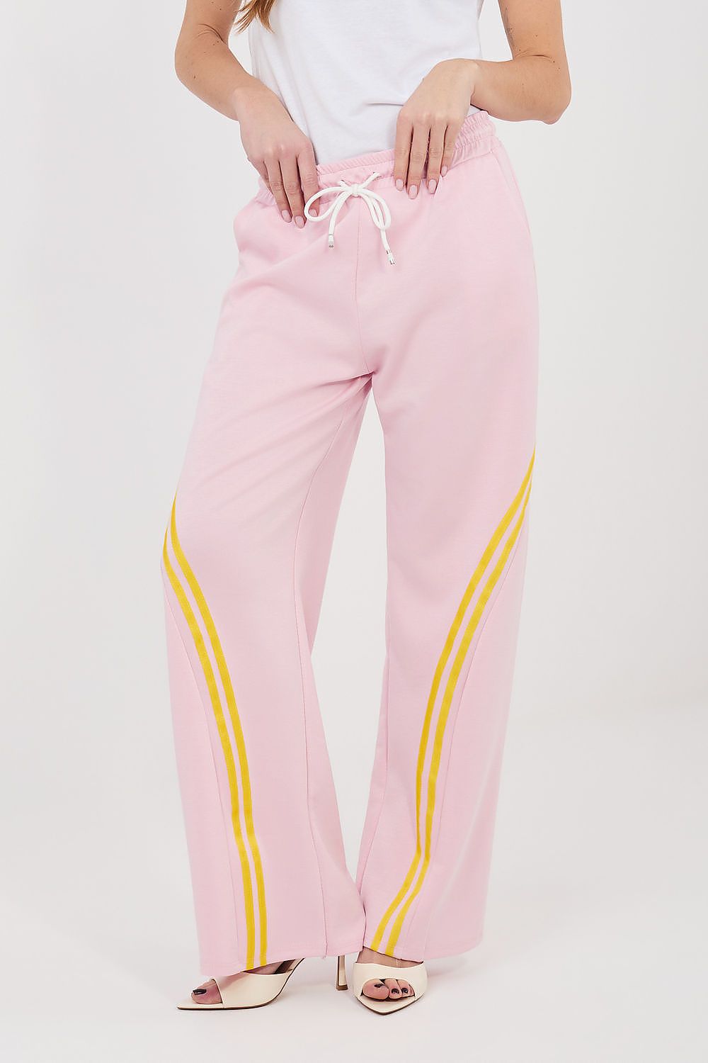 Pink tracksuit trousers with drawstring waist and yellow side stripe accents.
